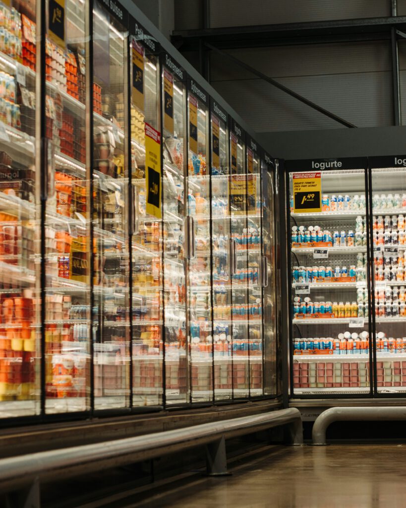 Convenient Kids Snacks: The Key to Consistent Healthy Snacking for Kids 2 A refrigerated grocery store aisle filled with a wide variety of packaged snacks, yogurts, and drinks, highlighting convenient snack options for kids.